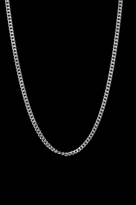 Sterling silver curb or Cuban link necklace hung in a U against a pure black background — stand-in photograph