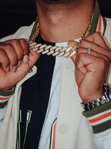 A gold chain worn over a plain tee, showing its width and length — stand-in photograph